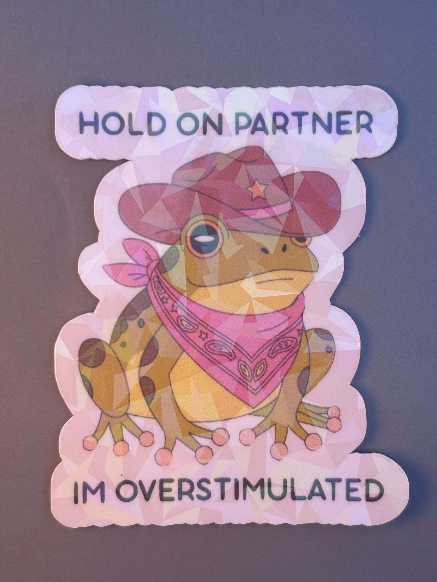 Hold On Partner I’m Overstimulated Holographic Sticker | Funny Frog Vinyl Decal | Mental Health Humor Sticker | Anxiety Gift | Cute Cowboy Frog Laptop Water Bottle Sticker